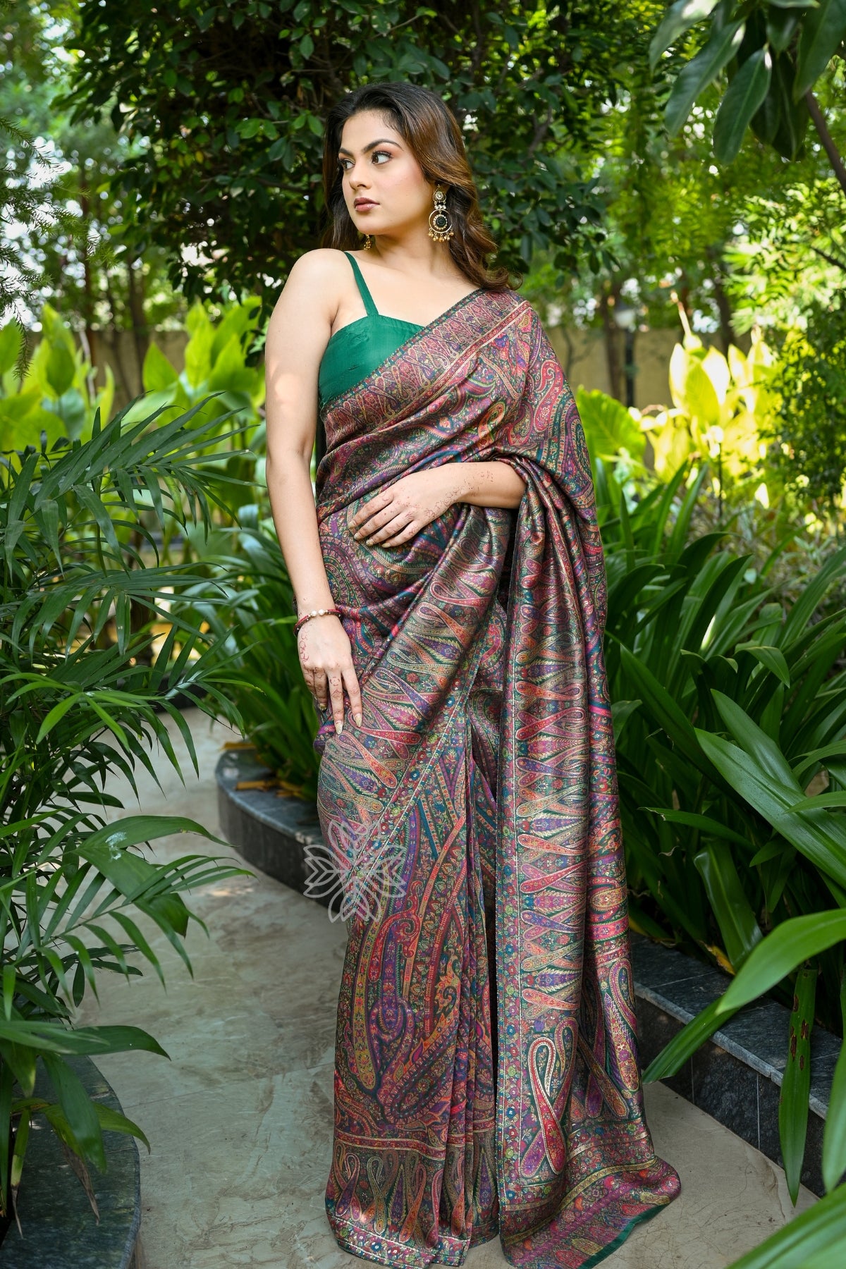 Woman wearing a saree in a garden setting - Green Kani Jamawar Silk Saree