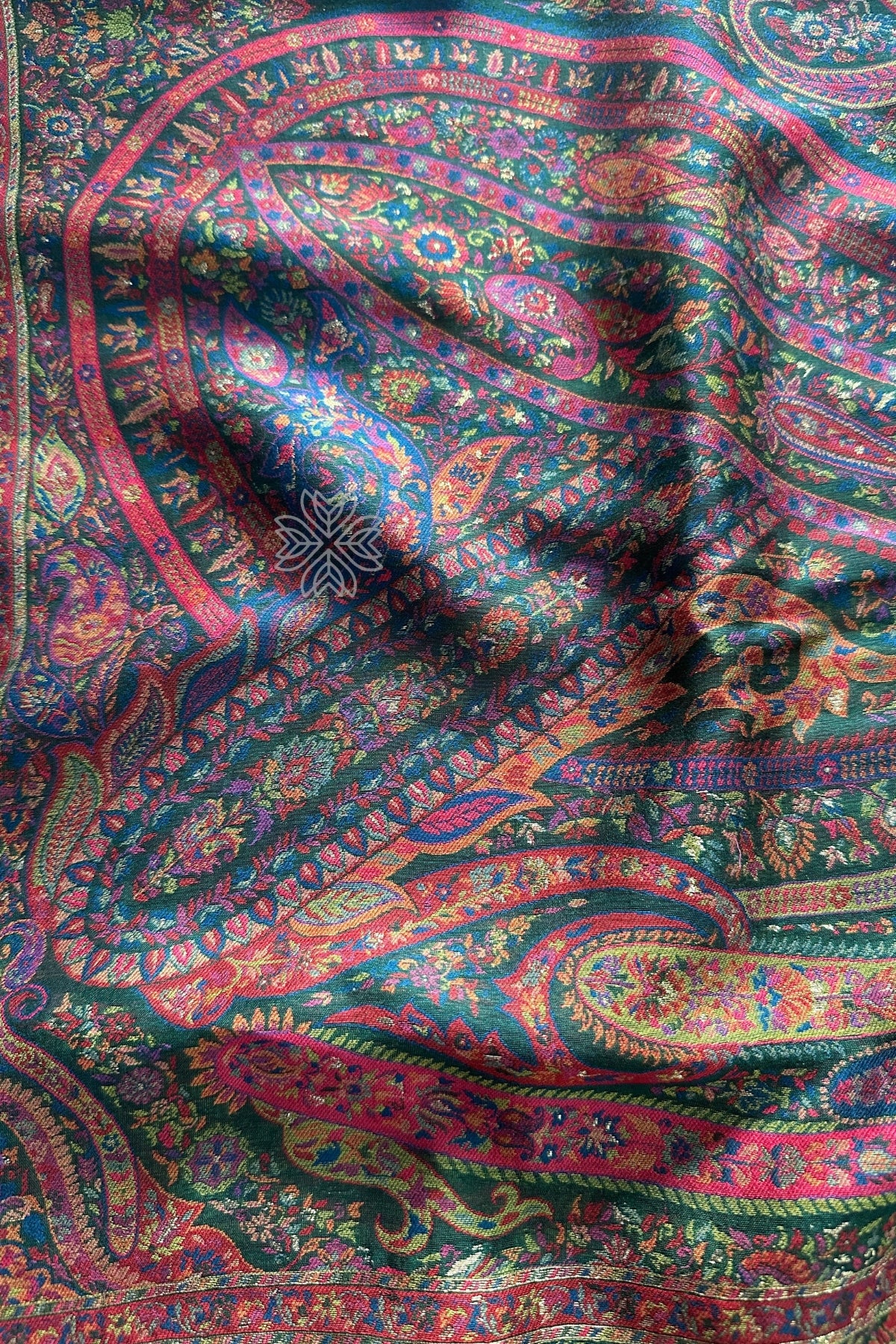 Close-up of a colorful paisley patterned fabric Green Kani Jamawar Silk Saree