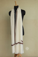 White scarf with brown trim