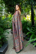 Woman in a colorful saree standing in a garden setting Green Pashmina Silk Saree