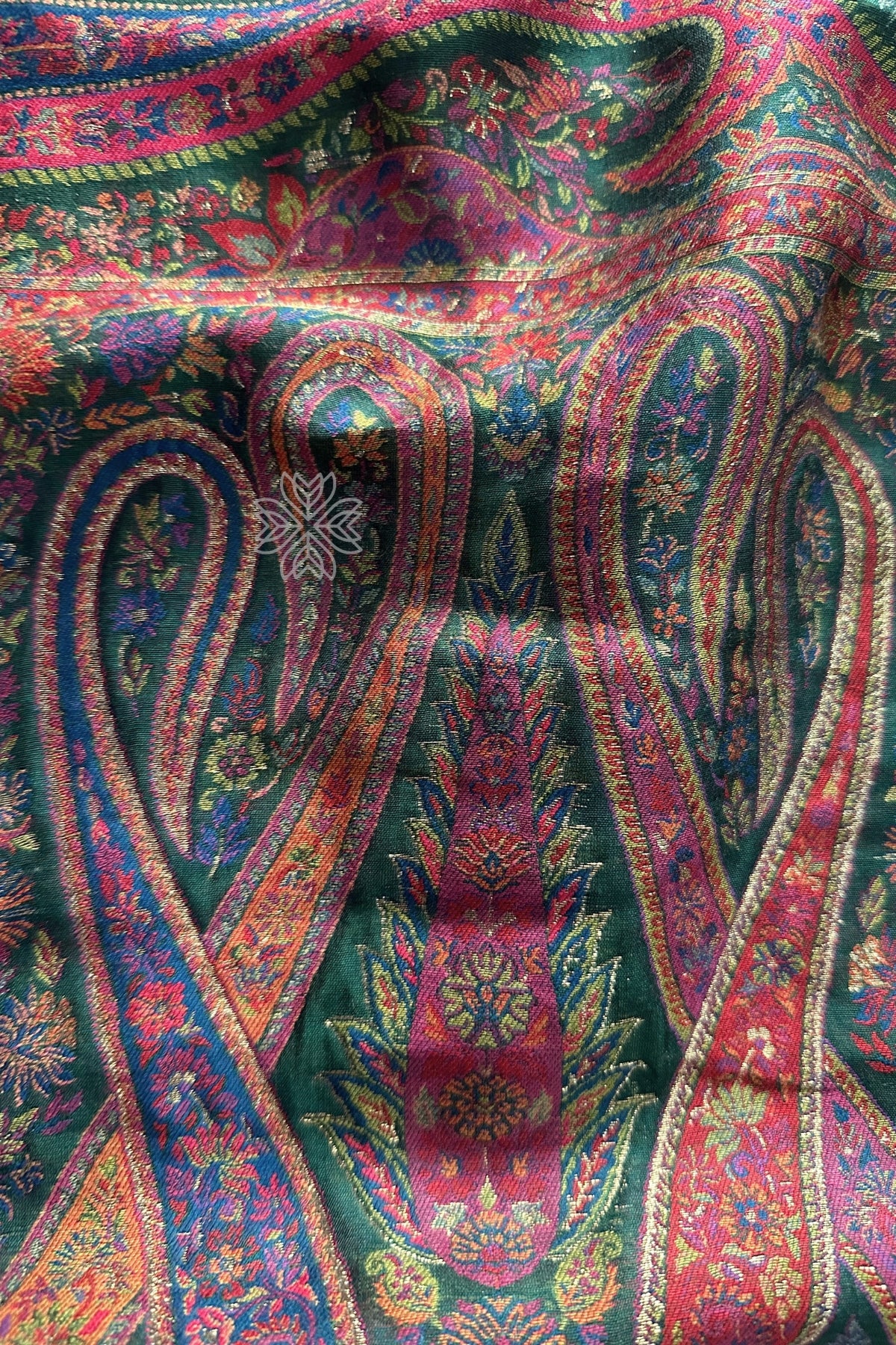 Close-up of a colorful paisley patterned fabric Green Kani Jamawar Silk Saree