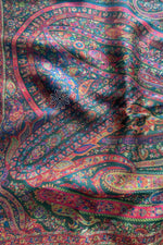 Close-up of a colorful paisley patterned fabric Green Kani Jamawar Silk Saree
