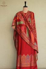Festive wear red traditional outfit with a matching patterned silk shawl.
