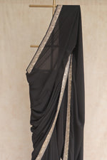 Black saree with gold border 